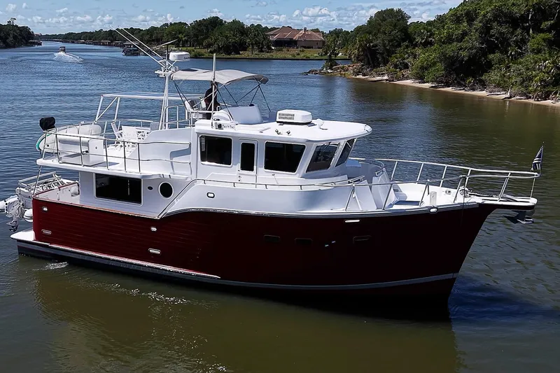 Slide: The Image of 2003 Magna Marine Nova Scotia 47 yacht cruising on a scenic river. - 0