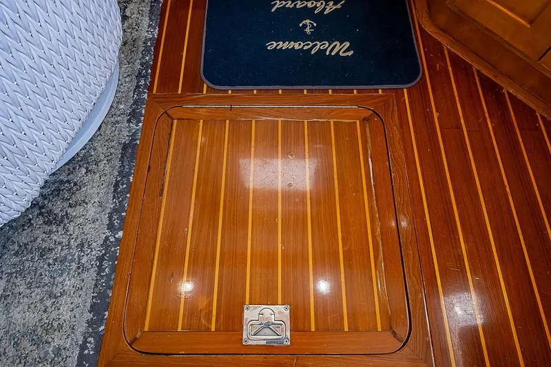 Slide: The Image of Teak flooring on 2003 Magna Marine Nova Scotia 47 yacht, featuring a hatch and welcome mat. - 15