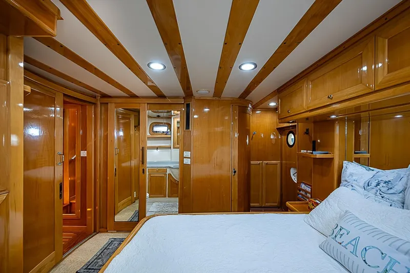 Slide: The Image of Luxurious 2003 Magna Marine Nova Scotia 47 yacht cabin with elegant wood finish and cozy bedding. - 22