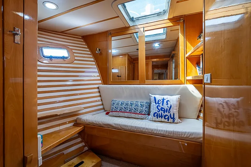 Slide: The Image of Cozy interior of 2003 Magna Marine Nova Scotia 47 yacht with striped walls and cushions. - 26