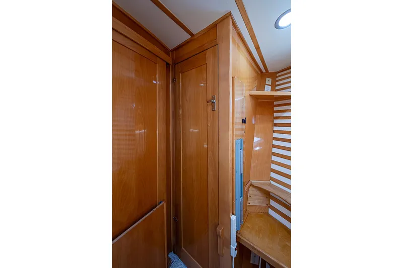 Slide: The Image of Wooden interior of 2003 Magna Marine Nova Scotia 47 boat, featuring cabinets and shelves. - 27