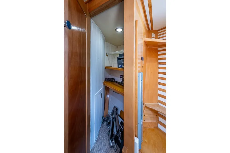 Slide: The Image of Interior of a boat with wooden shelves and a door to a small room. - 28