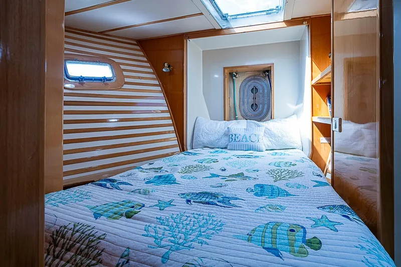 Slide: The Image of Cozy cabin interior of 2003 Magna Marine Nova Scotia 47 with nautical-themed bedding. - 29