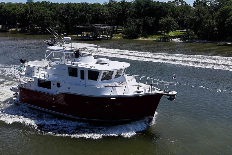 Slide: The Image of A 2003 Magna Marine Nova Scotia 47 yacht cruising on a scenic river. - 3