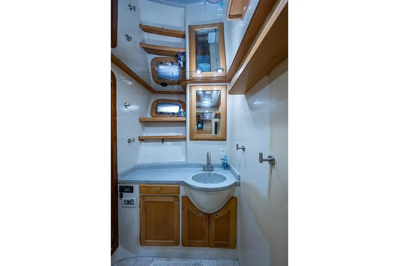 Slide: The Image of Luxurious bathroom in 2003 Magna Marine Nova Scotia 47 yacht, featuring wooden cabinetry and modern fixtures. - 30