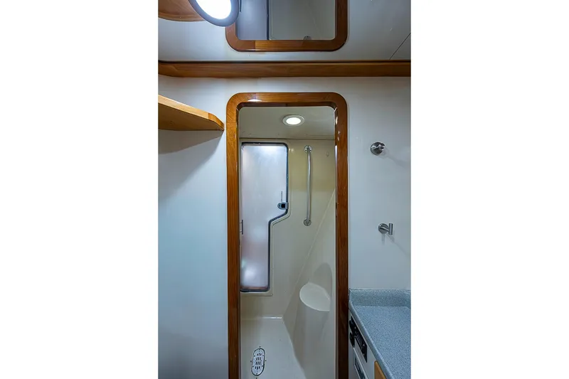 Slide: The Image of Bathroom interior of 2003 Magna Marine Nova Scotia 47 yacht, featuring shower and wooden trim. - 32