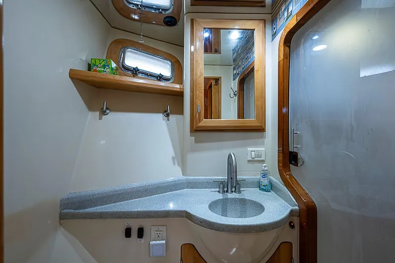 Slide: The Image of Luxurious bathroom interior of 2003 Magna Marine Nova Scotia 47 yacht, featuring modern sink and mirror. - 34