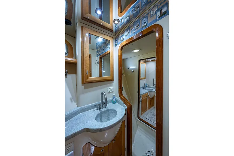 Slide: The Image of Luxurious bathroom interior of 2003 Magna Marine Nova Scotia 47 yacht, featuring elegant wood accents. - 35