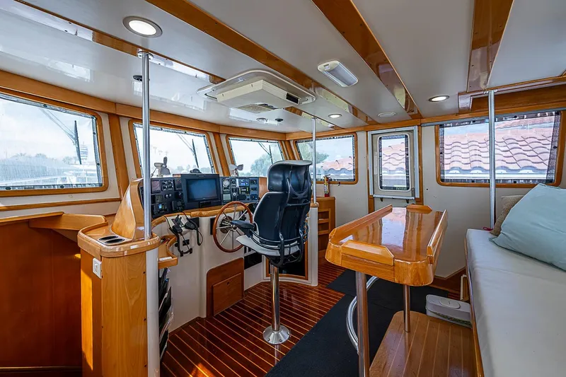 Slide: The Image of Interior of 2003 Magna Marine Nova Scotia 47, featuring helm, seating, and wooden accents. - 36