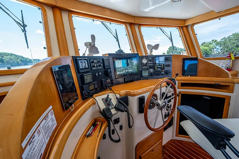 Slide: The Image of Helm of 2003 Magna Marine Nova Scotia 47, featuring navigation instruments and wooden steering wheel. - 39