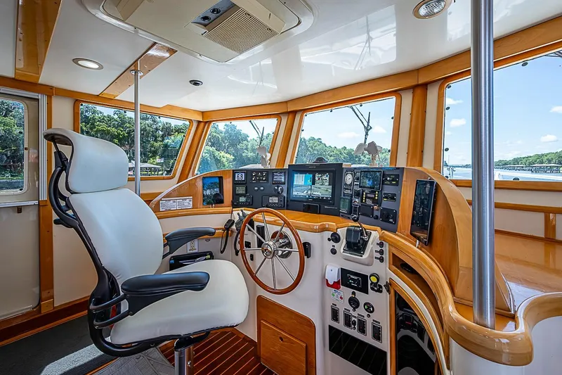 Slide: The Image of Luxurious helm of 2003 Magna Marine Nova Scotia 47 yacht with advanced navigation controls. - 40