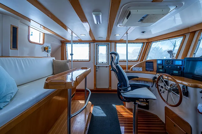 Slide: The Image of Interior of 2003 Magna Marine Nova Scotia 47, featuring helm, seating, and wooden accents. - 42