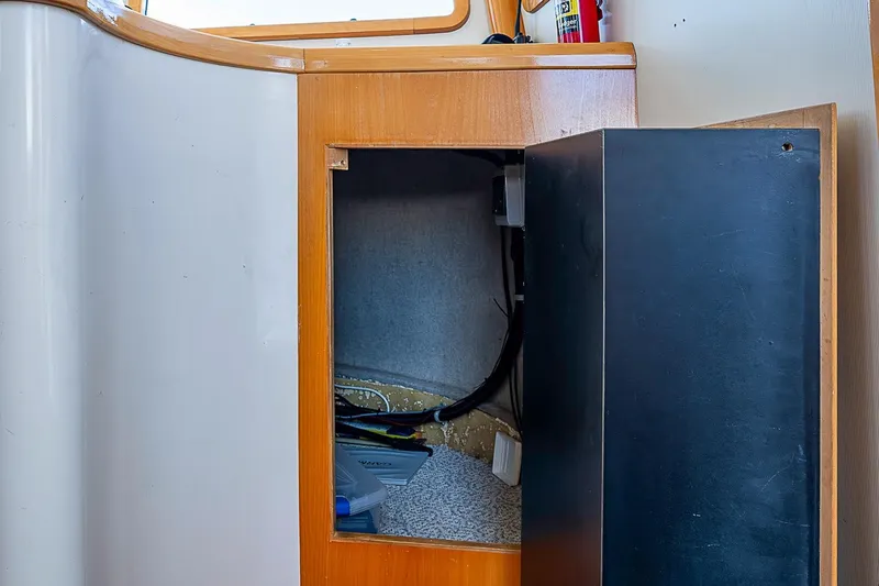Slide: The Image of Open cabinet on 2003 Magna Marine Nova Scotia 47 boat, revealing interior storage space. - 47