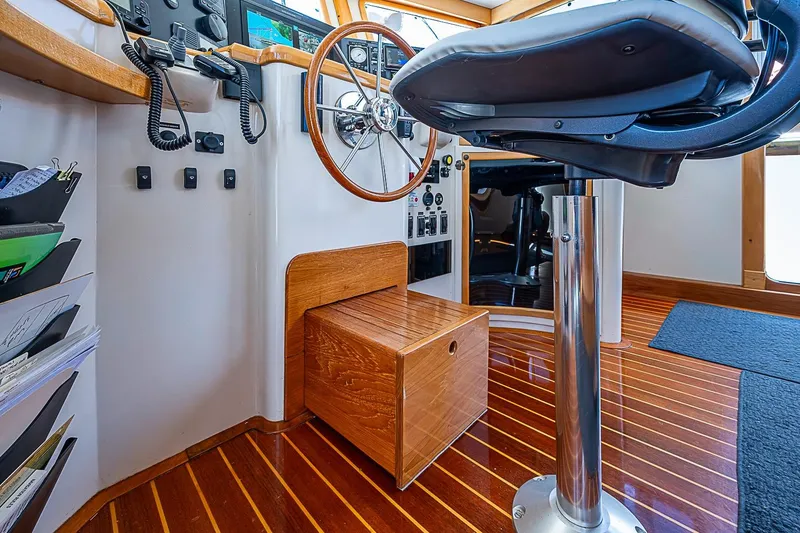 Slide: The Image of Helm station of 2003 Magna Marine Nova Scotia 47 with wooden accents and modern controls. - 49