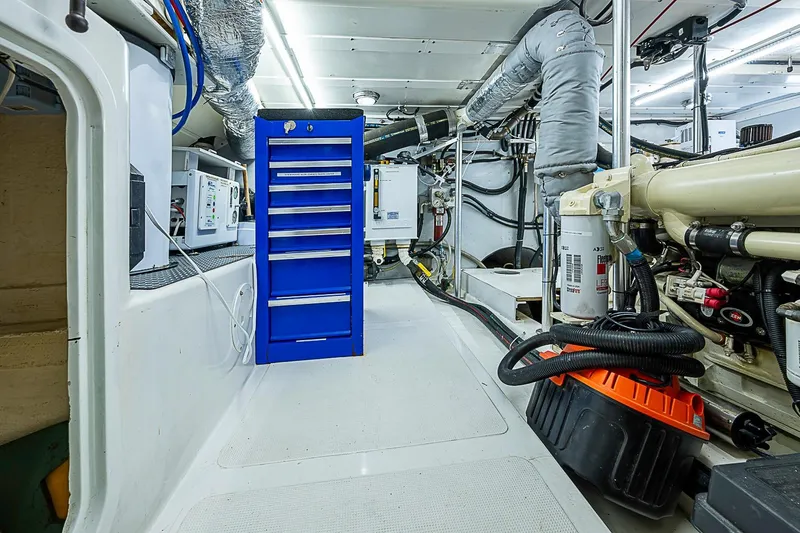 Slide: The Image of Engine room of 2003 Magna Marine Nova Scotia 47 with blue tool cabinet and machinery. - 51