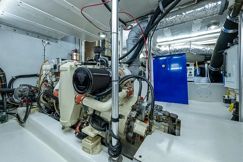 Slide: The Image of Engine room of 2003 Magna Marine Nova Scotia 47, showcasing mechanical components and wiring. - 54