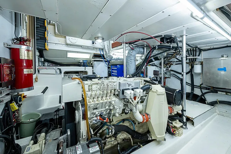Slide: The Image of Engine room of 2003 Magna Marine Nova Scotia 47, featuring mechanical components and fire safety equipment. - 55