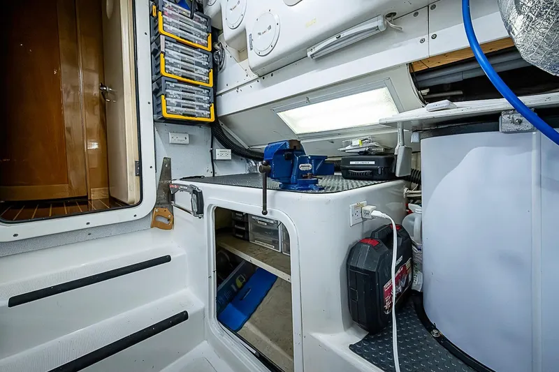 Slide: The Image of Engine room of 2003 Magna Marine Nova Scotia 47 with organized tools and equipment. - 62