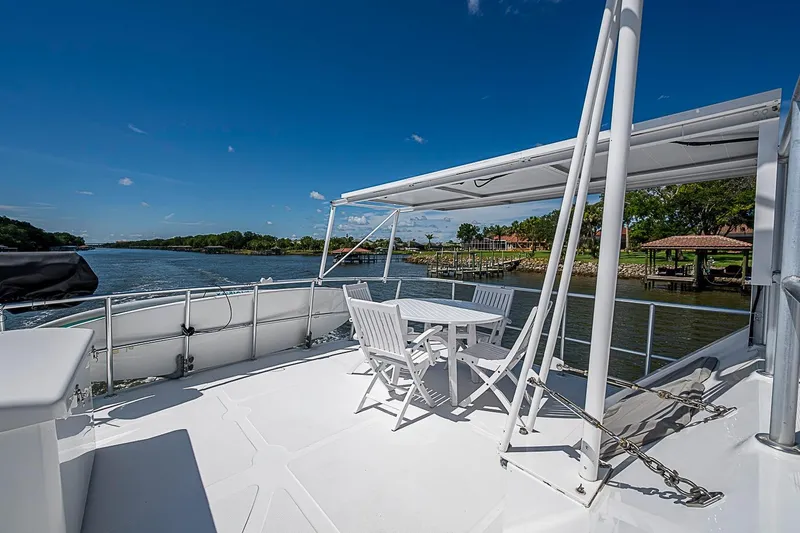 Slide: The Image of Deck view of 2003 Magna Marine Nova Scotia 47 yacht with outdoor seating and scenic waterway. - 64
