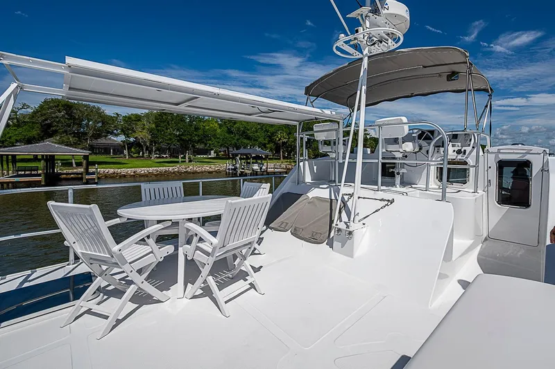 Slide: The Image of 2003 Magna Marine Nova Scotia 47 yacht deck with seating and helm under blue sky. - 65