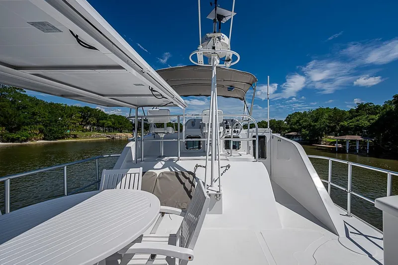 Slide: The Image of 2003 Magna Marine Nova Scotia 47 yacht deck with seating, under clear blue skies. - 67