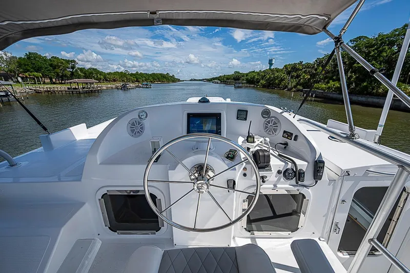 Slide: The Image of Cockpit view of 2003 Magna Marine Nova Scotia 47 yacht on a scenic river. - 68