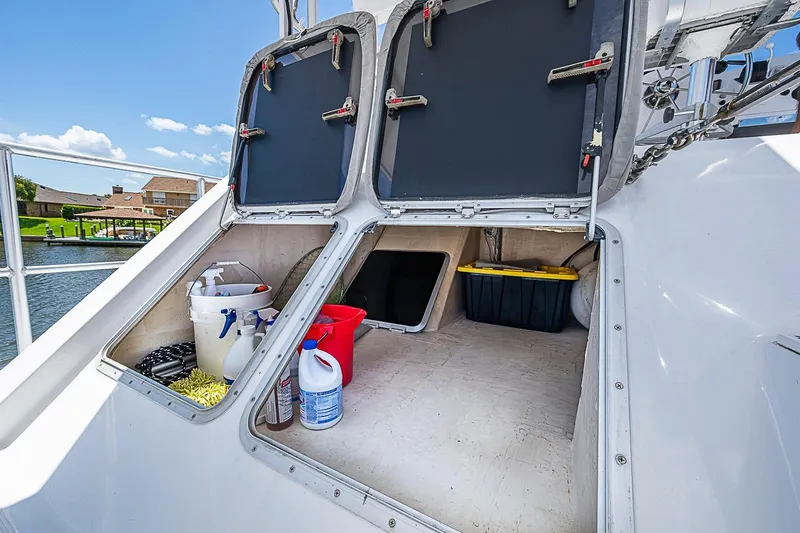 Slide: The Image of Storage compartments on a 2003 Magna Marine Nova Scotia 47 boat, containing cleaning supplies. - 71