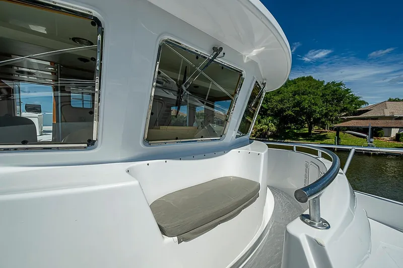 Slide: The Image of 2003 Magna Marine Nova Scotia 47 boat deck with cushioned seating and scenic waterfront view. - 73