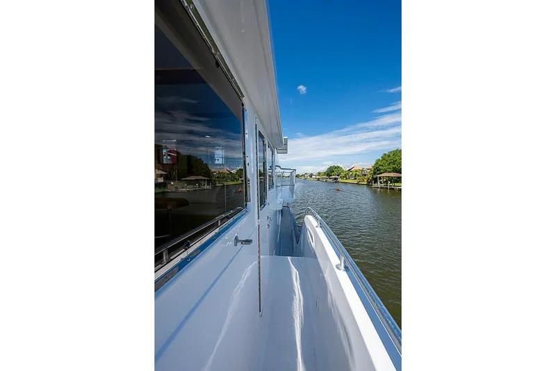 Slide: The Image of Side view of 2003 Magna Marine Nova Scotia 47 yacht on a serene river. - 76