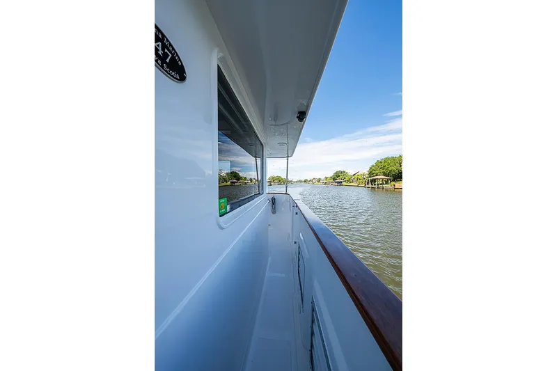 Slide: The Image of Side view of 2003 Magna Marine Nova Scotia 47 yacht on a serene river. - 77