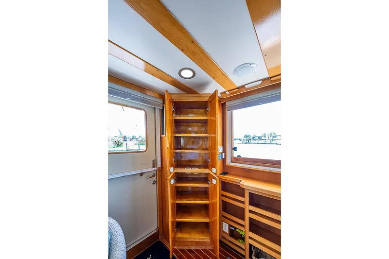 Slide: The Image of Interior of 2003 Magna Marine Nova Scotia 47, featuring wooden cabinetry and windows. - 9