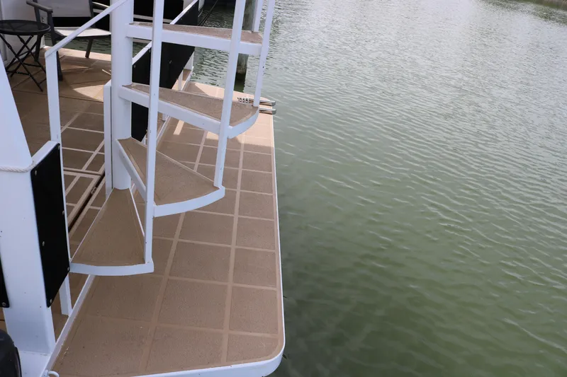 Slide: The Image of Staircase on 2010 Skipperliner 480 Flybridge yacht by the water. - 10
