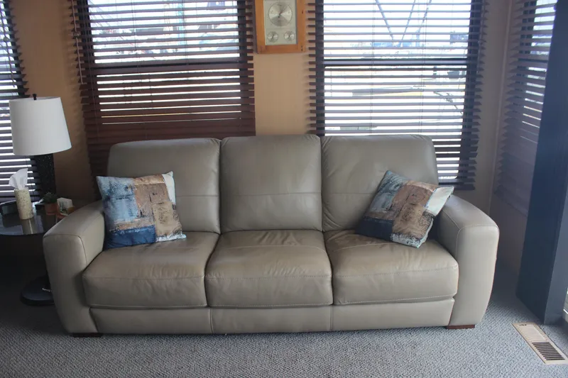 Slide: The Image of Beige leather sofa with decorative pillows in a cozy room on a Skipperliner 480 Flybridge. - 19