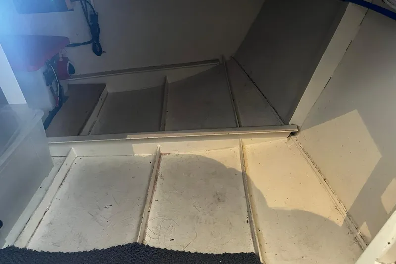 Slide: The Image of Interior view of a 2010 Skipperliner 480 Flybridge boat, showcasing steps and storage area. - 21