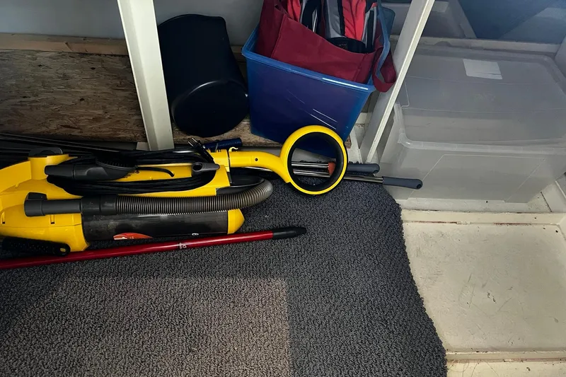 Slide: The Image of Storage area on Skipperliner 480 Flybridge 2010 with cleaning equipment and containers. - 22
