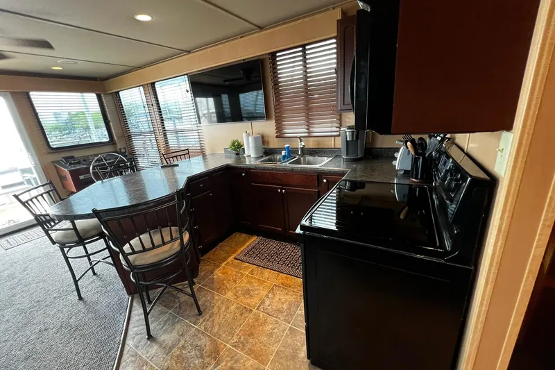 Slide: The Image of Interior of 2010 Skipperliner 480 Flybridge with modern kitchen and dining area. - 27