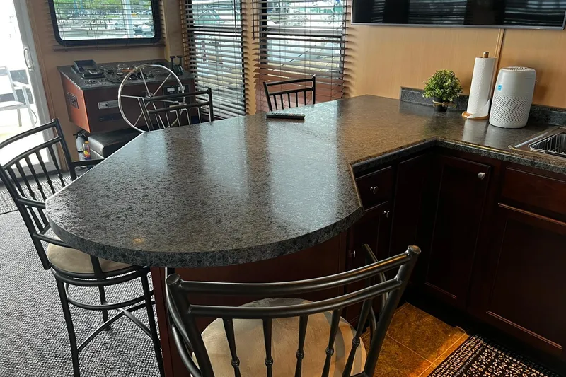 Slide: The Image of Luxurious interior of 2010 Skipperliner 480 Flybridge with modern kitchen and seating area. - 30