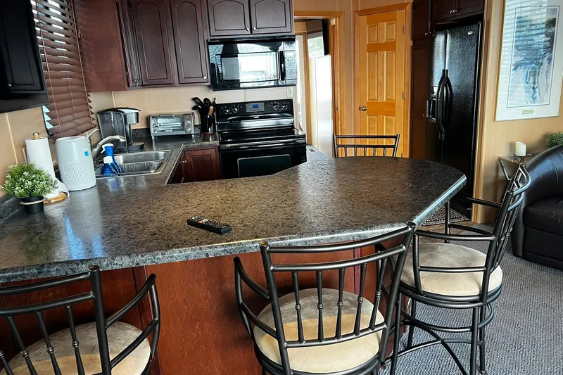 Slide: The Image of Modern kitchen interior on a 2010 Skipperliner 480 Flybridge yacht with bar seating. - 31