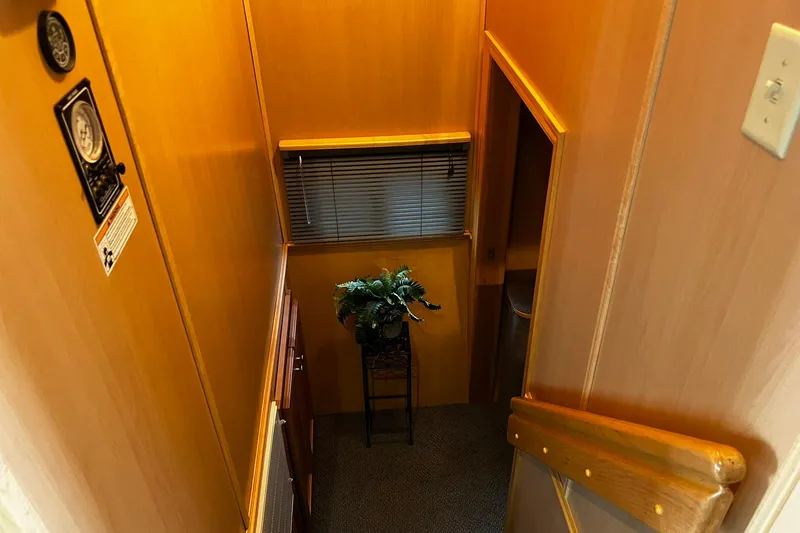 Slide: The Image of Interior of 2010 Skipperliner 480 Flybridge with wooden walls and decorative plant. - 32