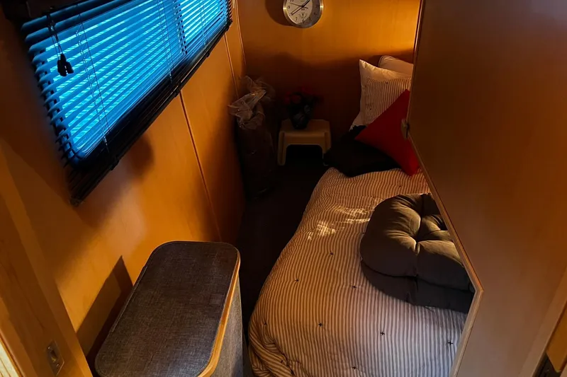 Slide: The Image of Cozy cabin interior of 2010 Skipperliner 480 Flybridge with bed and window blinds. - 33