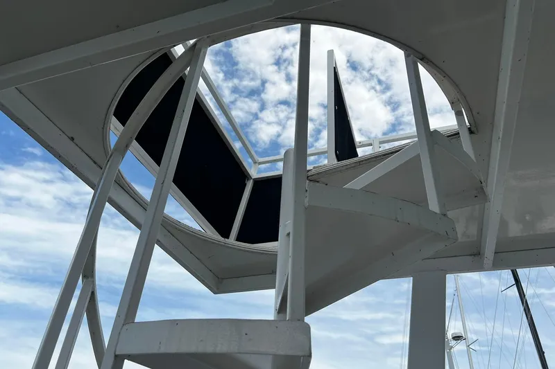 Slide: The Image of Spiral staircase on 2010 Skipperliner 480 Flybridge against a cloudy sky. - 40