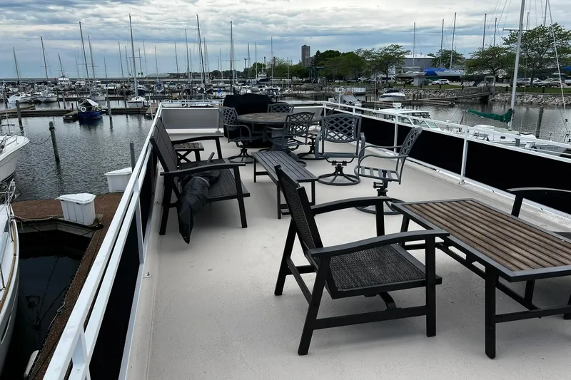 Slide: The Image of Flybridge deck of 2010 Skipperliner 480 with outdoor seating, overlooking marina. - 42