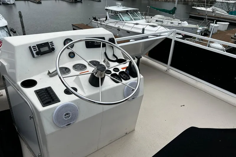 Slide: The Image of Flybridge helm of 2010 Skipperliner 480, featuring steering wheel and control panel. - 46