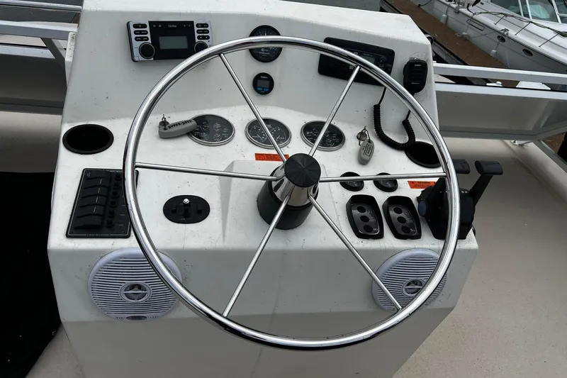 Slide: The Image of Helm of 2010 Skipperliner 480 Flybridge with steering wheel and control panel. - 47