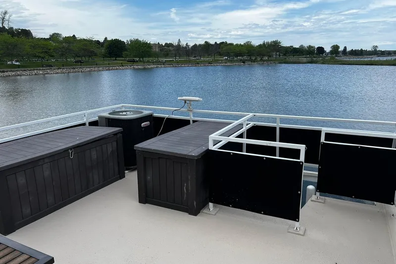 Slide: The Image of 2010 Skipperliner 480 Flybridge deck overlooking serene lake and lush shoreline. - 50
