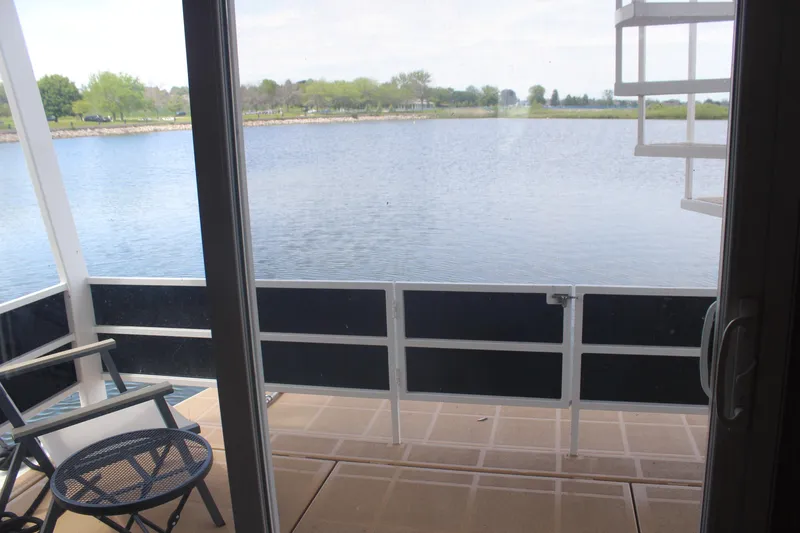 Slide: The Image of View from Skipperliner 480 Flybridge 2010, overlooking serene lake and lush greenery. - 6