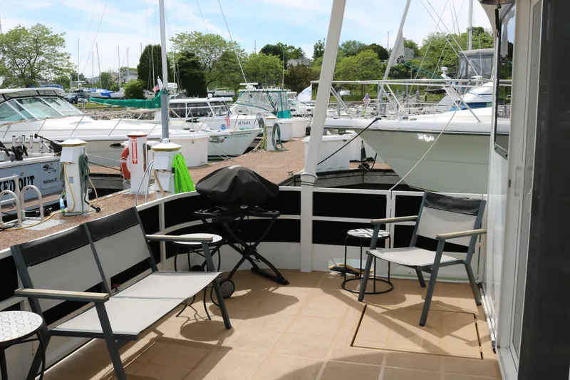 Slide: The Image of Outdoor seating area on a 2010 Skipperliner 480 Flybridge yacht at a marina. - 7