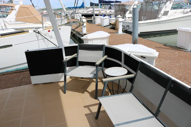 Slide: The Image of Outdoor seating area on 2010 Skipperliner 480 Flybridge yacht at marina. - 8
