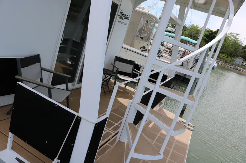 Slide: The Image of 2010 Skipperliner 480 Flybridge with spiral staircase and outdoor seating on deck. - 9