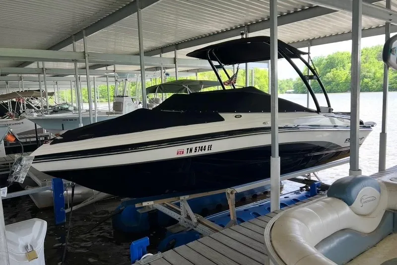 The Image of 2013 Bryant 210 Walkabout boat docked in a covered marina. - 0